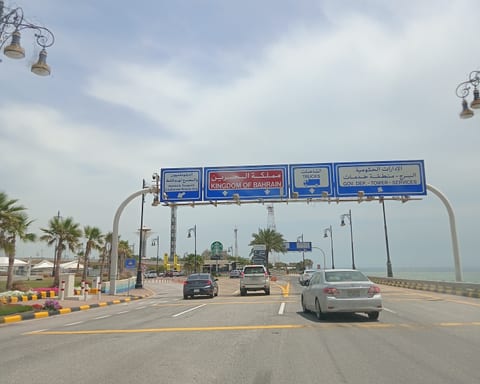 Lanes at the Bahrain–Saudi Arabia border crossing on the King Fahd Causeway, with a sign for trucks
