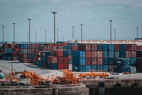 Stacked shipping containers in a port yard